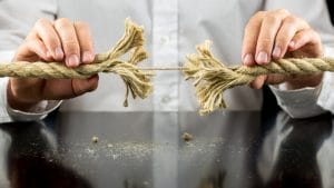 Man holding a rope with one remaining string